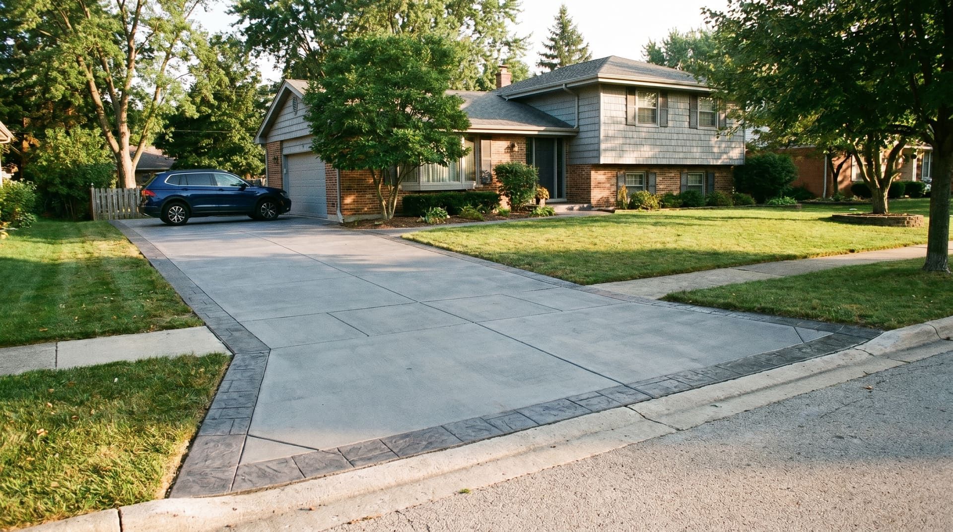 Newly poured concrete driveway with broom finish and crisp control-joint grid