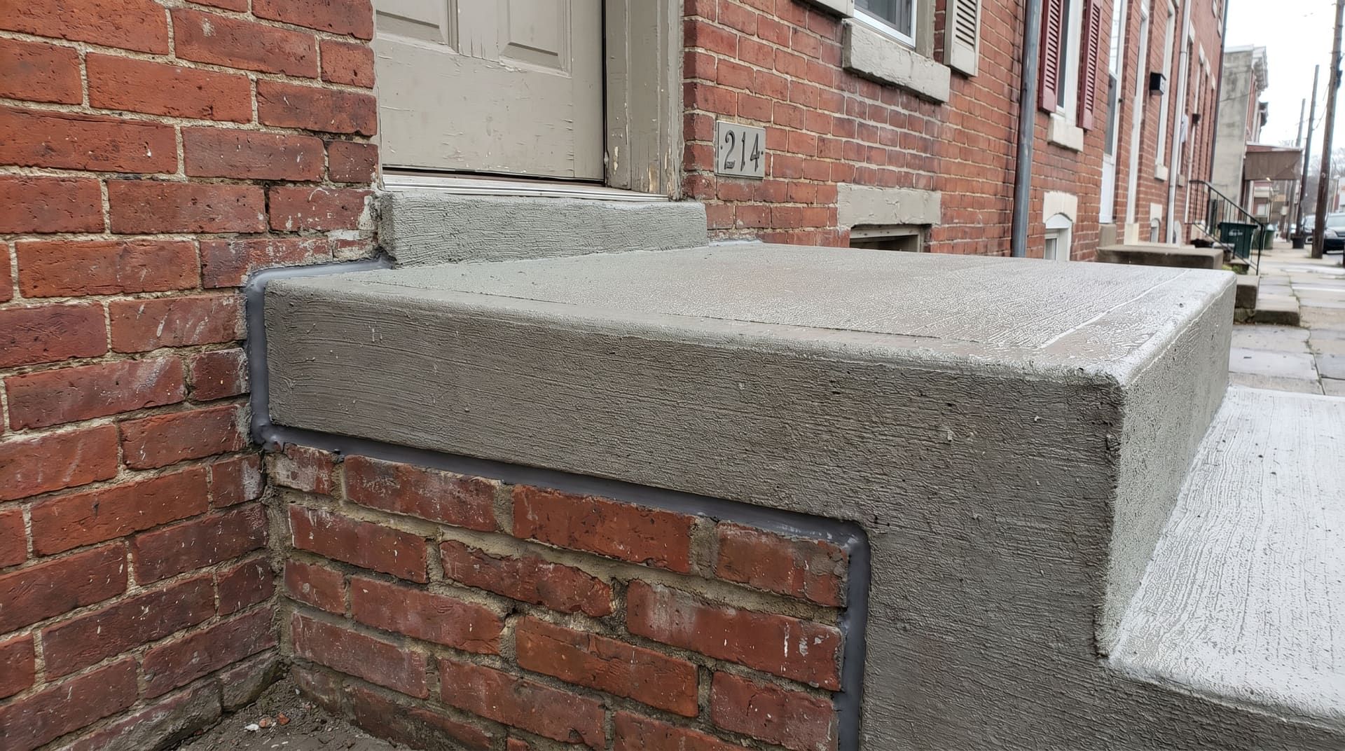 Form-built front stoop with deep footing and bluestone tread cap